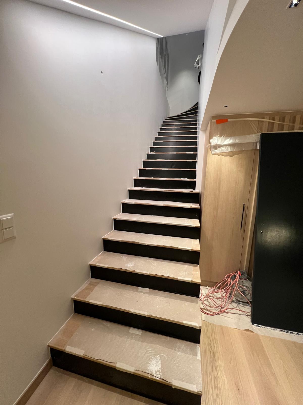 Escalier rénové avec contremarches noires laquées et marches en bois clair